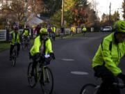 Cyclists practice riding single file and allowing sufficient space to avoid collisions while riding through Vancouver&#039;s Evergreen Highlands neighborhood on Monday night.