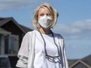 Lisa Bayautet wears her N95 face mask near her Vancouver home. Bayautet takes medication for psoriatic arthritis that suppresses her immune system, making her especially vulnerable to illness in her daily life.