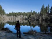 Cherie Kearney, forest conservation director for Columbia Land Trust, looks over Kwoneesum Lake on Tuesday morning. The M.J. Murdock Charitable Trust will provide $450,000 for the Columbia Land Trust to purchase 1,300 acres in Skamania County along Wildboy Creek, a tributary to the West Fork Washougal River. The property, which is currently owned by Weyerhaeuser Co., includes a 45-foot-high dam that the Cowlitz Indian Tribe intends to remove.