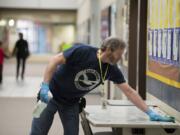 Mike Rodgers, building operator at Lake Shore Elementary School, wipes down tables in a hallway with disinfectant during preventative cleaning for COVID-19, as recommended by Clark County Public Health. Currently, the county has no confirmed cases of COVID-19, and officials said this was normal preventative cleaning.