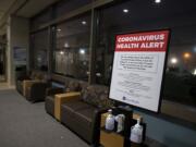 A coronavirus health alert sign is posted at one of the entrances to the Firstenburg Tower at PeaceHealth Southwest Medical Center on Monday morning, March 9, 2020.