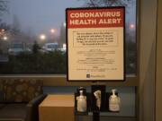 A coronavirus health alert sign is posted at one of the entrances to the Firstenburg Tower on Monday morning at PeaceHealth Southwest Medical Center.