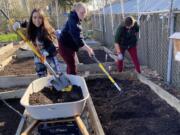 HAZEL DELL: From left, Karmia Keffer, Megan Ulrich, and Deborah Cronemeyer work at the Hazel Dell School and Community Garden. Thirty-seven Clark College student made a difference by helping prepare garden for spring.