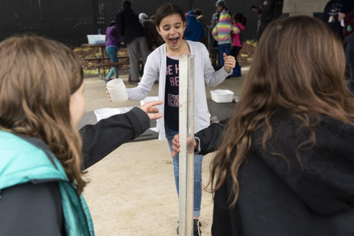 Kimberlynn Troyer, a third-grader in Pat Harmon&#039;s Maple Grove Primary School class, reacts as pond water overflows its container on Friday. Students in her group were testing the water&#039;s turbidity, a measure of how many particles it contained.