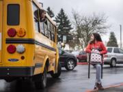 Trinity Breland, left, and Haydn Dorsey exchange phone numbers as Breland's bus pulls away from Covington Middle School so that the two can stay in touch on the final day of school for the 2019-2020 school year.