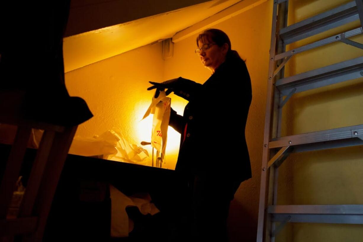 Allison Sosa, co-owner and event coordinator of Elements Restaurant in downtown Vancouver, prepares to-go cutlery for takeout orders. Like many restaurants still open, Elements has had to drastically shift its business model during the stay-at-home order from Gov. Jay Inslee.