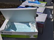 A box of procedure masks sits next to boxes of gloves as staff members await COVID-19 patients at PeaceHealth Southwest Medical Center on Friday afternoon.