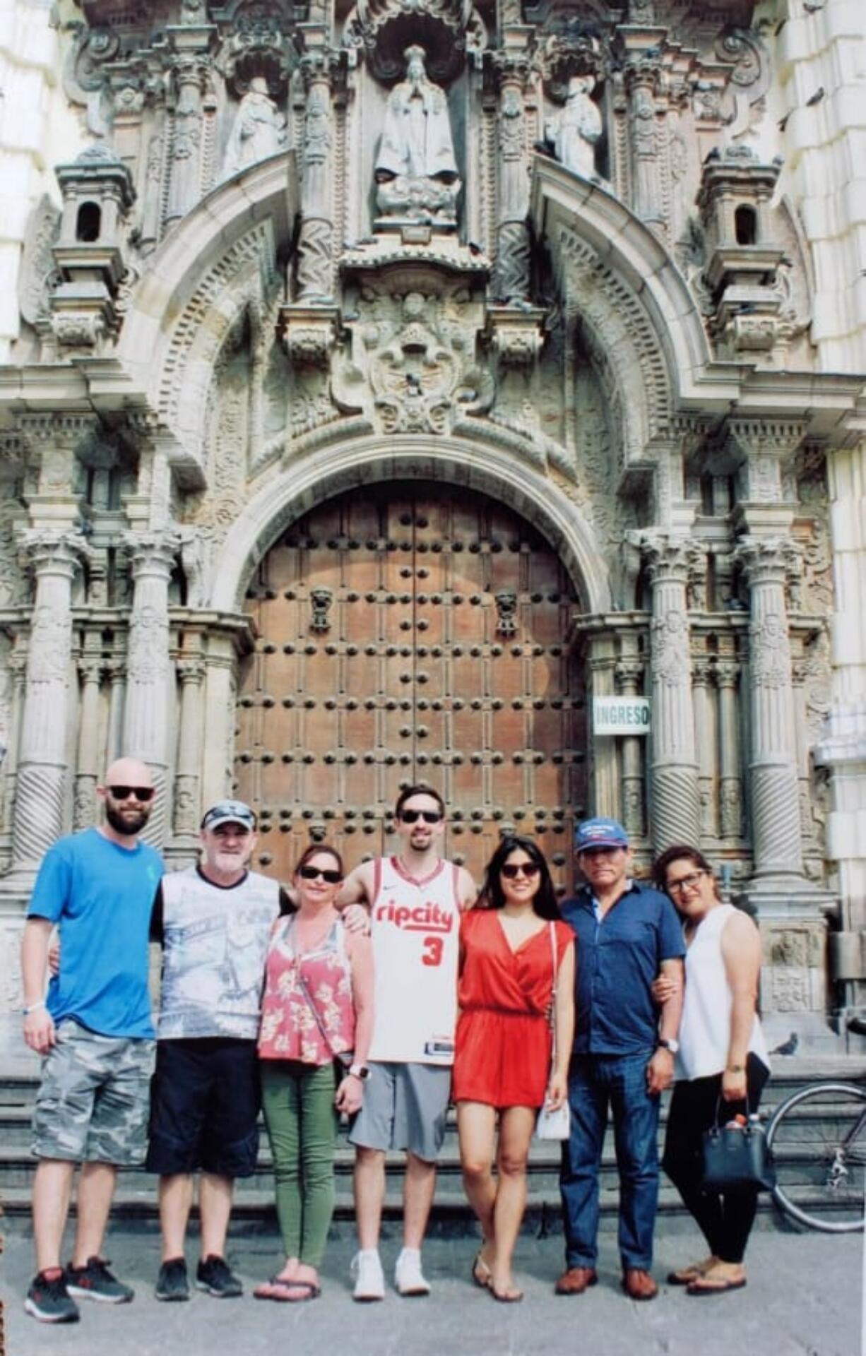 Heidi Marshall, third from left, poses with her family in front of the St. Francis Monastery in Lima, Peru. Marshall and four others are stuck near Lima after arriving on March 13 to visit her new in-laws.