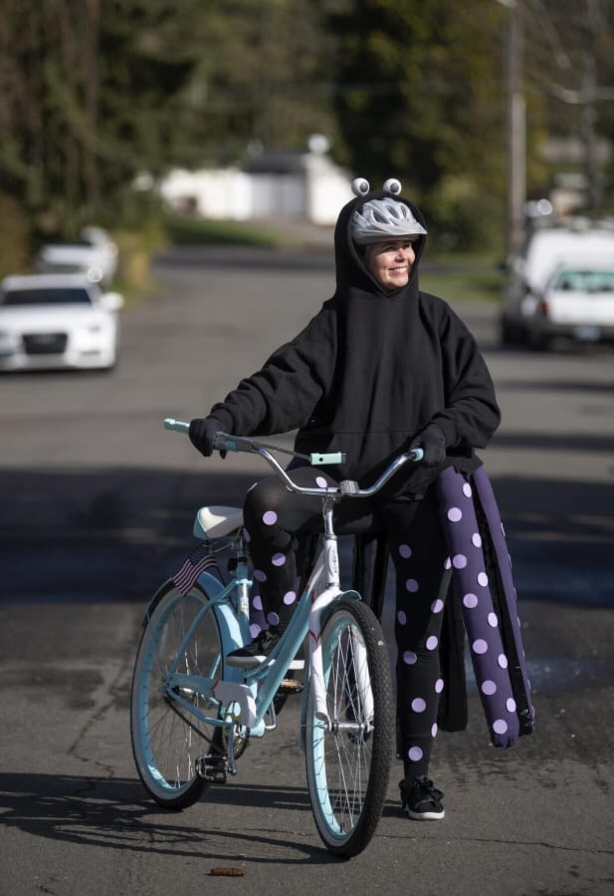 Vancouver Public Schools art teacher Jennifer Patton in the Edgewood Park neighborhood in Vancouver on Monday. Patton has dressed up and paraded her neighborhood for the past week to spread joy during the school closures. She plans on continuing this every day until schools open back up.