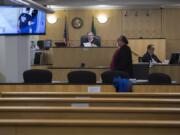 Judge Gregory Gonzales presides over a nearly empty courtroom while joined by attorney Jeff Sowder during first appearances in Clark County Superior Court on Tuesday morning. Gonzales was able to see and talk to the defendants through live video from the jail, a precaution being employed due to the COVID-19 pandemic.