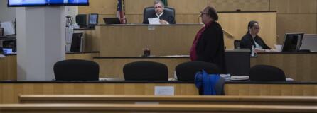 Judge Gregory Gonzales presides over a nearly empty courtroom while joined by attorney Jeff Sowder during first appearances in Clark County Superior Court on Tuesday morning. Gonzales was able to see and talk to the defendants through live video from the jail, a precaution being employed due to the COVID-19 pandemic.