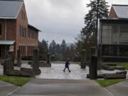 A lone pedestrian strolls through an empty campus at Washington State University Vancouver in late March.