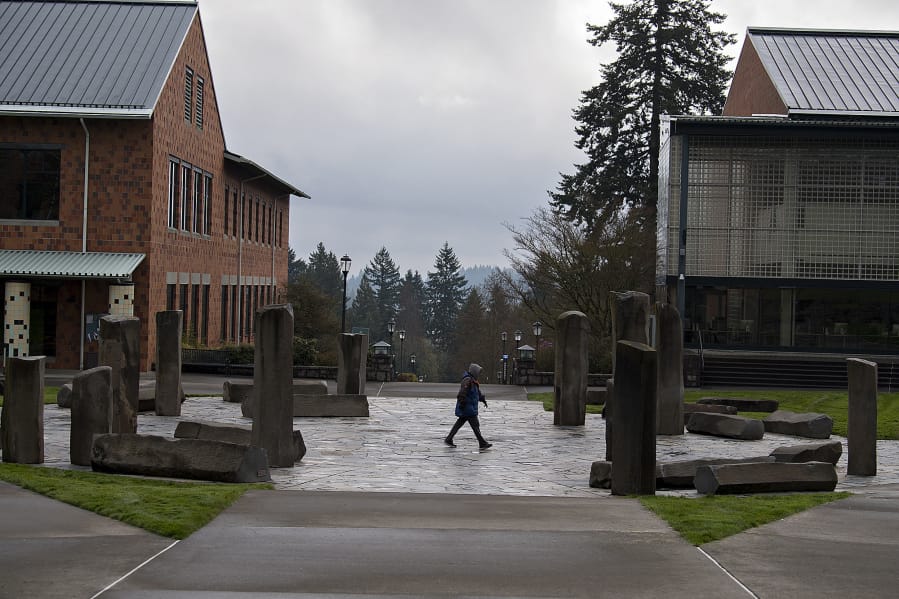 A lone pedestrian strolls through an empty campus at Washington State University Vancouver in late March.