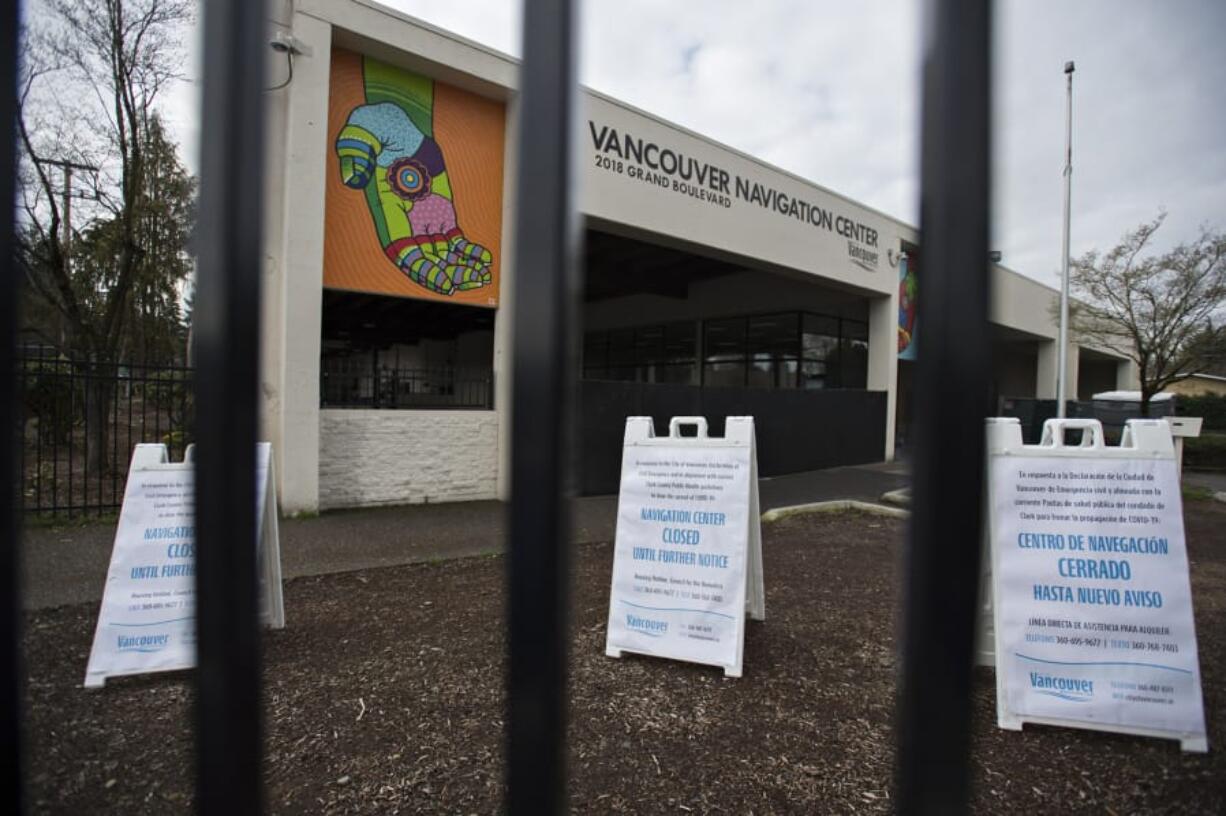 Signs outside the Vancouver Navigation Center in March 2020 notify visitors of the closure due to COVID-19 concerns.