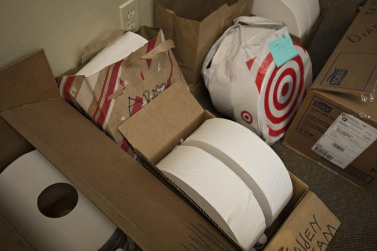 Oversized rolls of toilet paper are collected at In It Together RN in downtown Vancouver before being distributed to local adult family homes throughout Clark County.  Adult family homes are beginning to encounter shortages of necessities, such as toilet paper, and personal protective equipment.  &quot;This is a bigger problem than we realized,&quot; Beth Paul said.