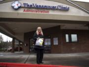 Nancy Bowser of Vancouver stands outside Vancouver Clinic&#039;s administrative office. A family friend in China sent Bowser 100 surgical masks and 10 N95 respirator masks from China. Bowser decided to donate them to Vancouver Clinic, which is short of masks. A spokeswoman for the clinic said it has received nearly 10,000 donated masks in the past week.