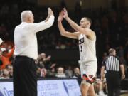 Oregon State's Tres Tinkle (3) high-fives his father, Oregon State head coach Wayne Tinkle, as Tres is subbed out in the last minute of his final home NCAA college basketball game, against California, in Corvallis, Ore., Saturday, March 7, 2020.