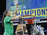 Oregon's Sabrina Ionescu (20) reacts while cutting down the net after defeating Stanford in an NCAA college basketball game in the final of the Pac-12 women's tournament Sunday, March 8, 2020, in Las Vegas.