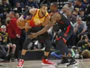 Toronto Raptors center Serge Ibaka (9) guards against Utah Jazz center Rudy Gobert (27) in the first half during an NBA basketball game Monday, March 9, 2020, in Salt Lake City.