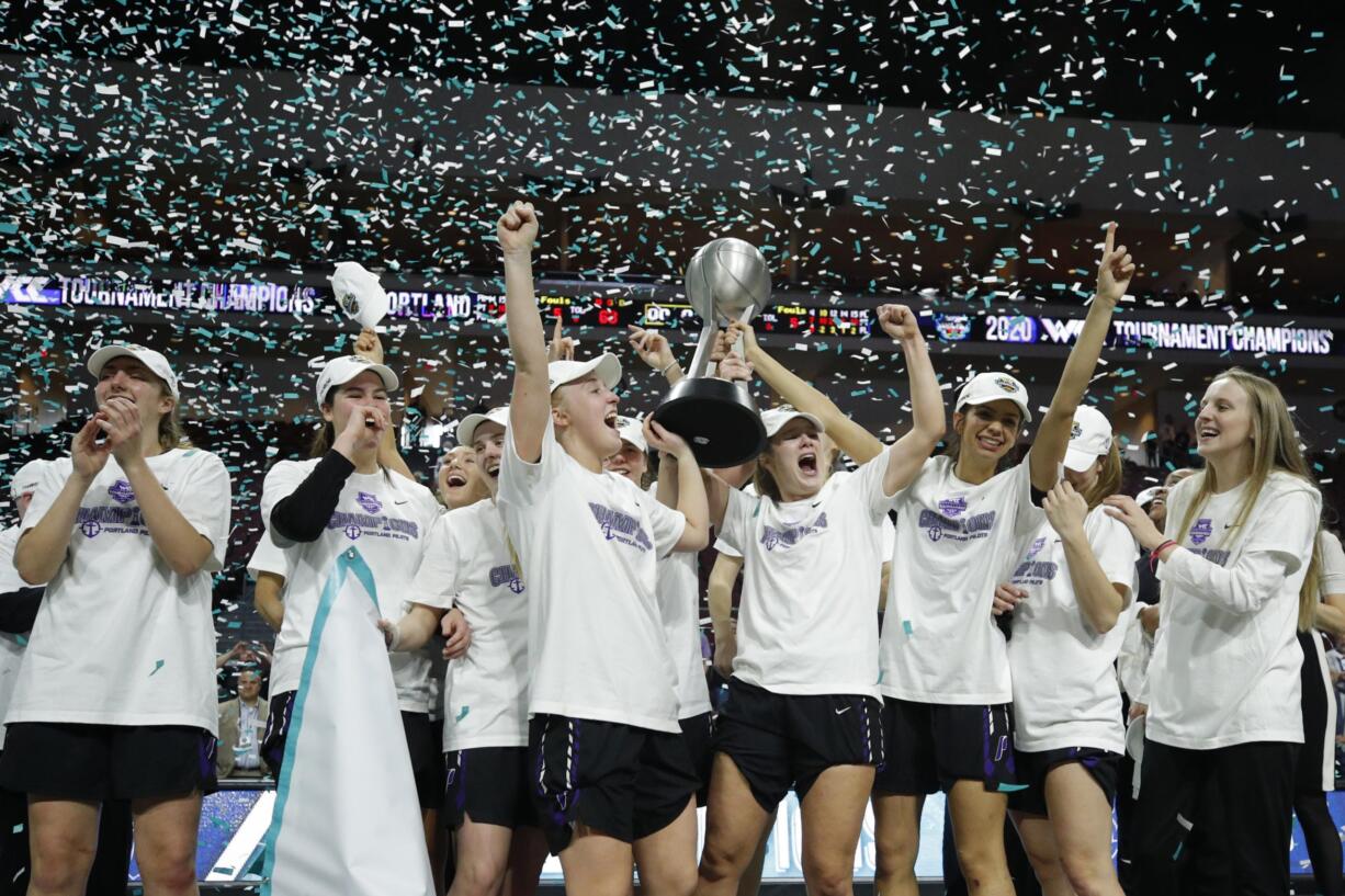 Portland players celebrate after defeating San Diego in an NCAA college basketball game in the final of the West Coast Conference women's tournament Tuesday, March 10, 2020, in Las Vegas.