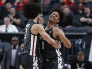 Washington State's CJ Elleby, left, and DJ Rodman celebrate after a play against Colorado during the second half of an NCAA college basketball game in the first round of the Pac-12 men's tournament Wednesday, March 11, 2020, in Las Vegas.