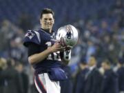 FILE - In this Jan. 4, 2020, file photo, New England Patriots quarterback Tom Brady warms up before an NFL wild-card playoff football game against the Tennessee Titans in Foxborough, Mass. Tom Brady is an NFL free agent for the first time in his career.  The 42-year-old quarterback with six Super Bowl rings  said Tuesday morning, March 17, 2020, that he is leaving the New England Patriots.