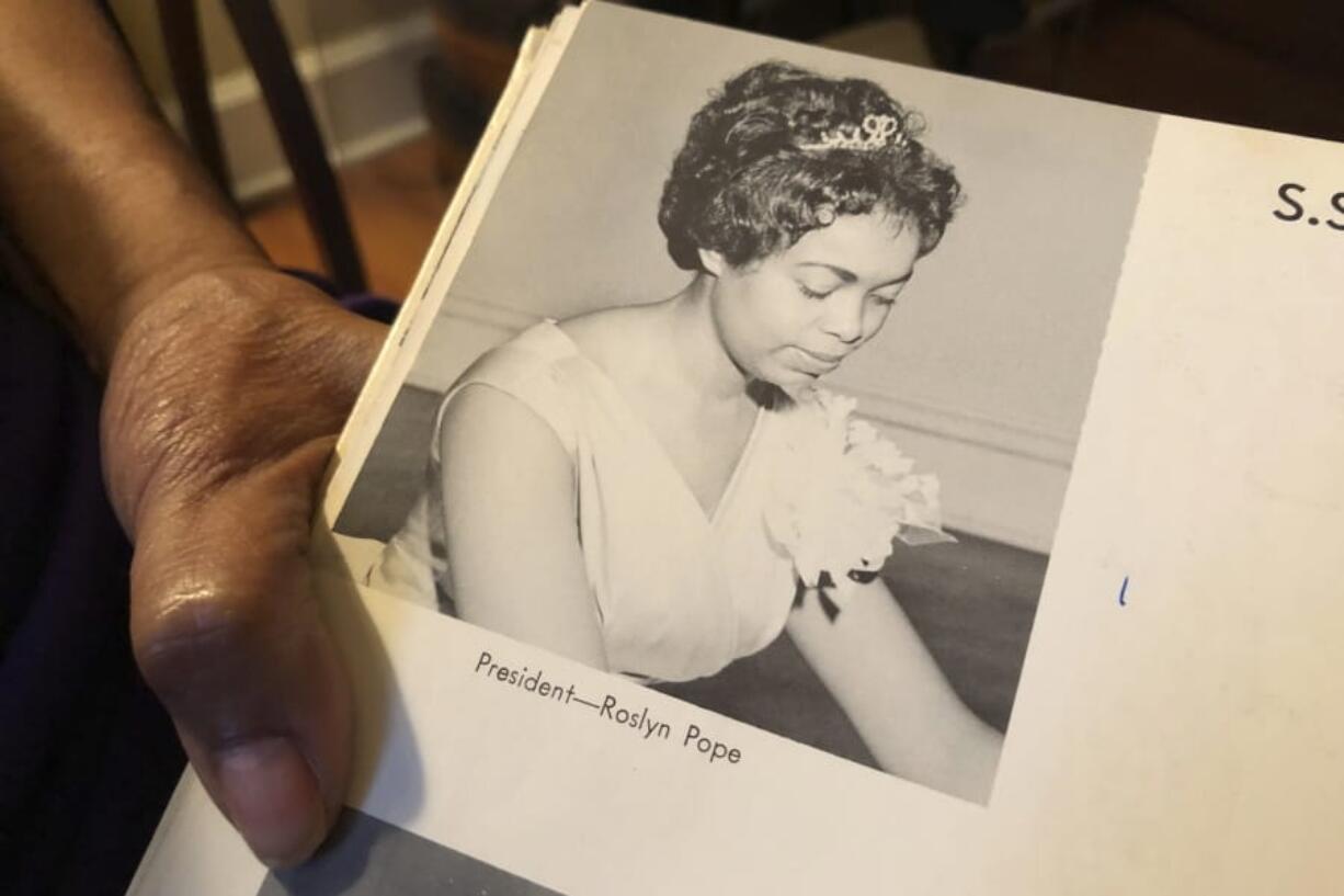 In this March 4, 2020 photo, Roslyn Pope shows her Spelman College yearbook at her home in Atlanta. As a 21-year-old Spelman senior in March 1960, Pope wrote &quot;An Appeal for Human Rights,&quot; a document that made the case for the Atlanta Student Movement, a nonviolent campaign of boycotts and sit-ins by black college students that protested racial segregation in education, jobs, housing, voting, hospitals, movies, concerts, restaurants and law enforcement.