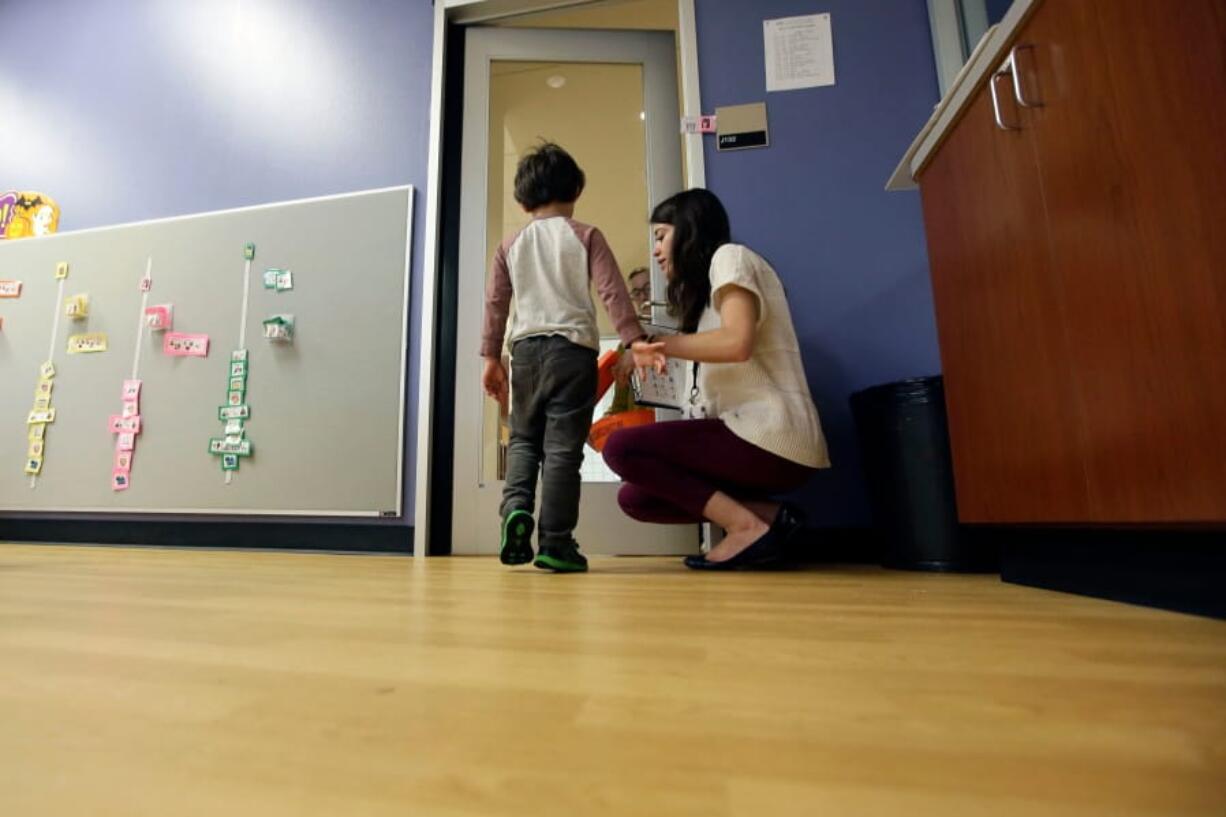 Megan Krail helps a 4-year-old boy with autism spectrum disorder practice trick-or-treating in 2016 at the University of Texas at Dallas&#039; Callier Center for Communication Disorders preschool class in Dallas.