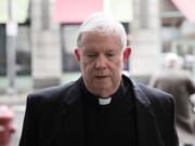 In this March 11, 2020 photo, Monsignor William Lynn arrives for a pretrial hearing at the center for criminal justice in Philadelphia. Lynn, 69, is the only Roman Catholic church official in the U.S. ever sent to prison over his handling of priest sex-abuse complaints. He has served 33 months in prison, but is set to be retried Monday, Monday, March 16, on a child endangerment charge after a Pennsylvania appeals court overturned his 2012 conviction.