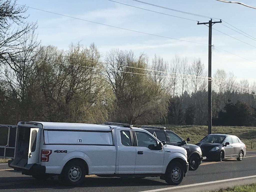 Law enforcement investigate the scene of a fatal crash on 78th Street on Friday morning.