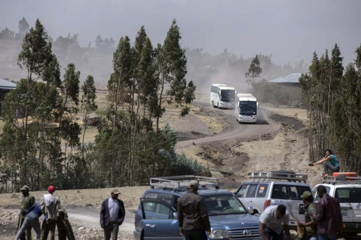 Relatives in buses arrive to attend the memorial service for the one-year anniversary of the crash of Ethiopian Airlines Flight ET302 in the rural Tulufera area near Bishoftu, south-east of the capital Addis Ababa, in Ethiopia Tuesday, March 10, 2020. Grim-faced, visibly grief-stricken, some crying, hundreds of family members gathered Tuesday for a memorial service at the site where one year ago the jet crashed into the rocky ground, killing all 157 on board.