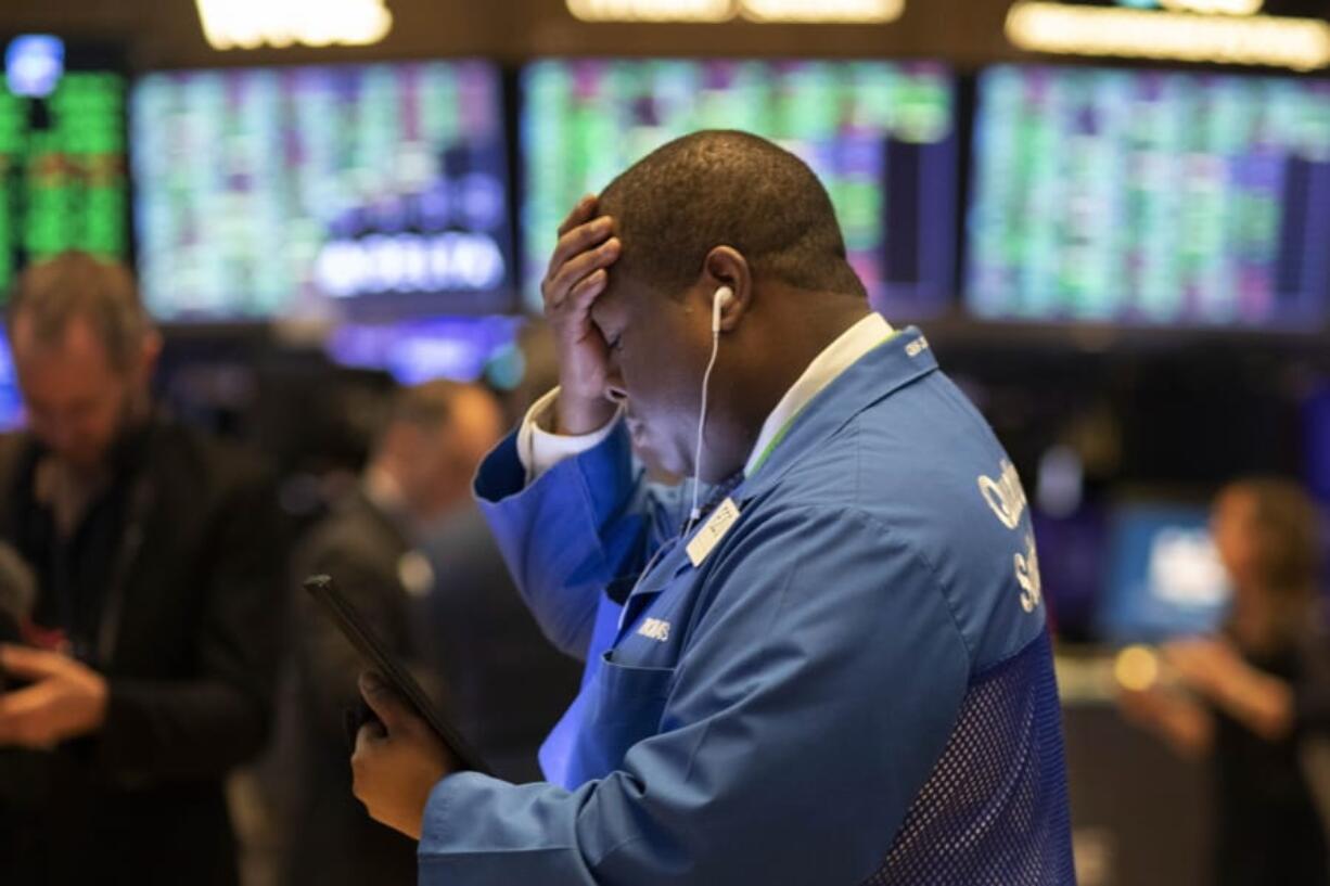 Stock trader Thomas Lee works at the New York Stock Exchange, Friday, March 13, 2020. Stocks are opening sharply higher on Wall Street a day after the worst drop since 1987.