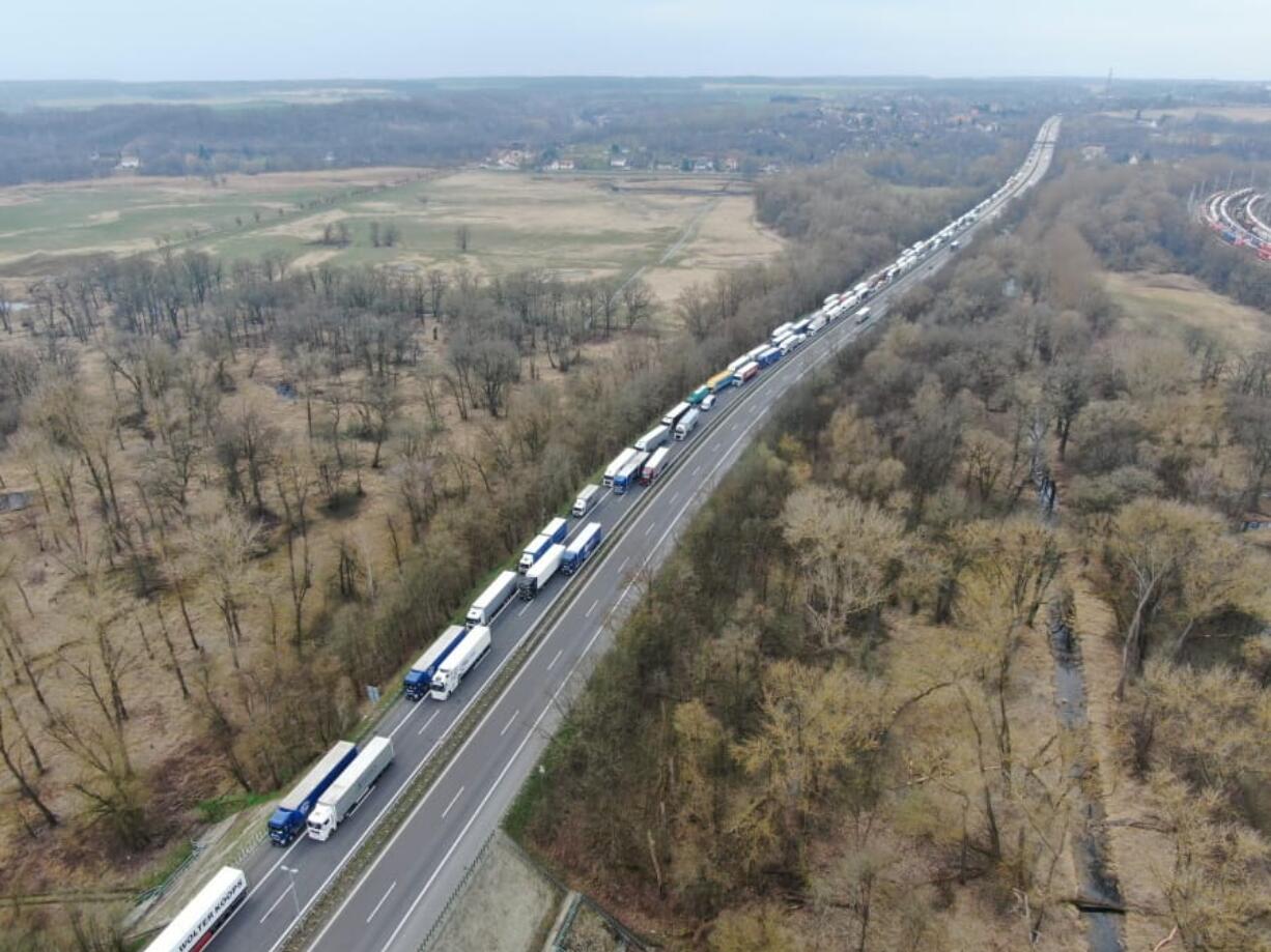 Trucks are stuck in traffic jams on the A12 autobahn in the direction of Poland near near Frankfurt (Oder), Germany, Tuesday, March 17, 2020. To make it more difficult for the corona virus to spread, Poland had reintroduced controls at the border crossings to Germany.