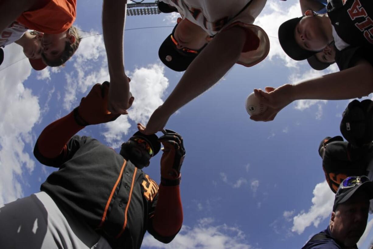 San Francisco Giants&#039; Pablo Sandoval signs autographs for fans before a spring training baseball game against the Arizona Diamondbacks, Monday, March 2, 2020, in Scottsdale, Ariz.(AP Photo/Darron Cummings)