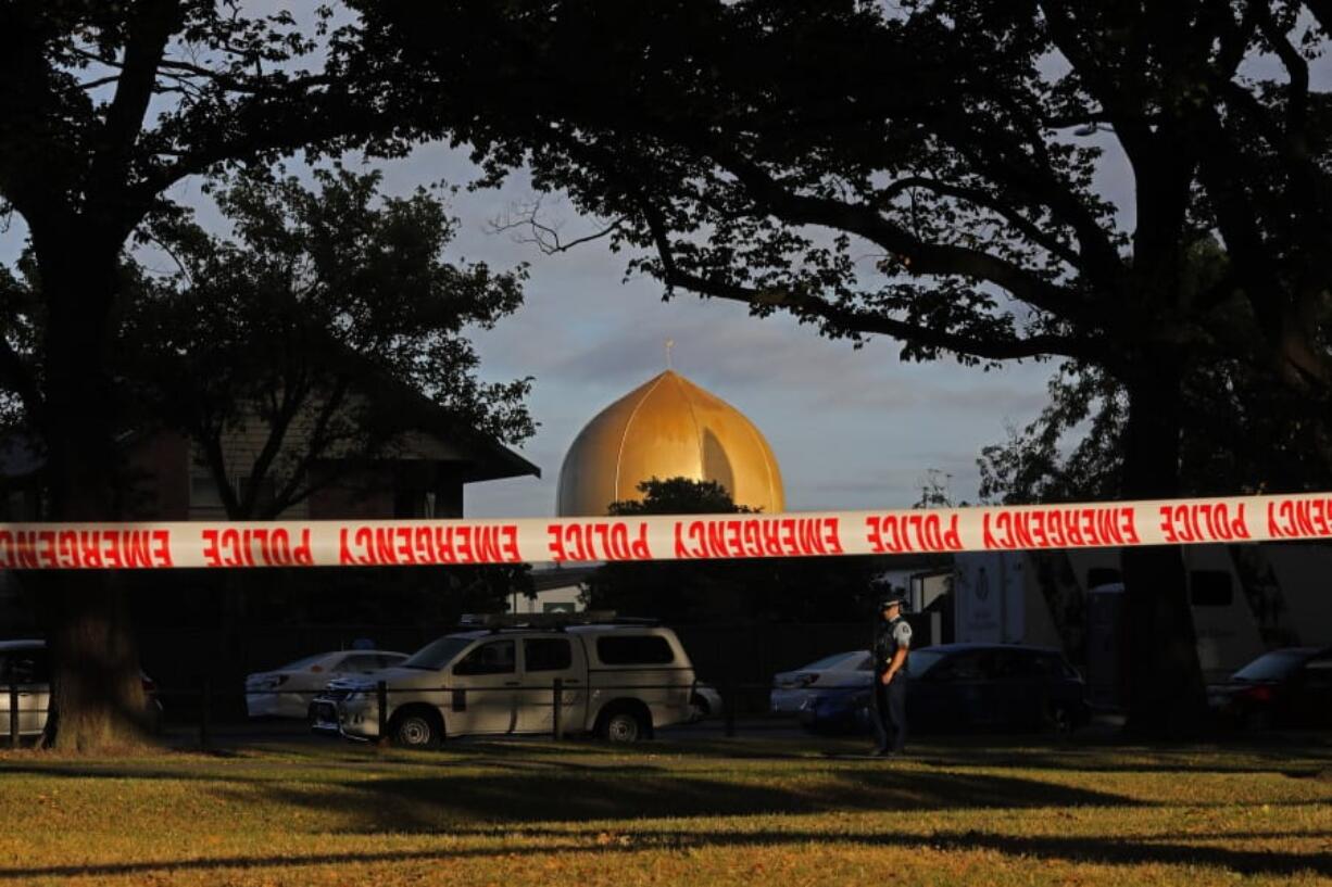 FILE - In this March 17, 2019 file photo, a police officer stands guard in front of the Masjid Al Noor mosque in Christchurch, New Zealand, where one of two mass shootings occurred. According to a report released Wednesday, March 18, 2020, by an organization that tracks far-right extremists, a recent surge in white nationalism in the U.S. has led to a growing threat of violence by factions that embrace bloodshed and advocate for a race war.  The man accused of attacking two mosques in Christchurch, New Zealand, and killing 51 people in March 2019 devoted a section of his manifesto to the concept of accelerationism, a fringe philosophy that promotes mass violence to fuel society&#039;s collapse.