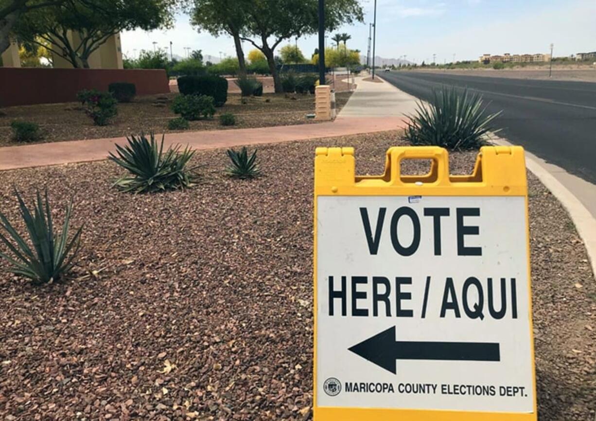 FILE - This April 11, 2018, file photo shows a sign directing voters to an early-voting location in Surprise, Ariz. Sharing the primary calendar Tuesday, March 17, 2020, are two states that represent different pieces of America: Ohio, a largely white state that&#039;s barely growing and looking to rebound from a decline in manufacturing, and Arizona, a state where one-third of the population is Latino and growth is exploding. One looks more like the nation&#039;s past, the other could be its future.