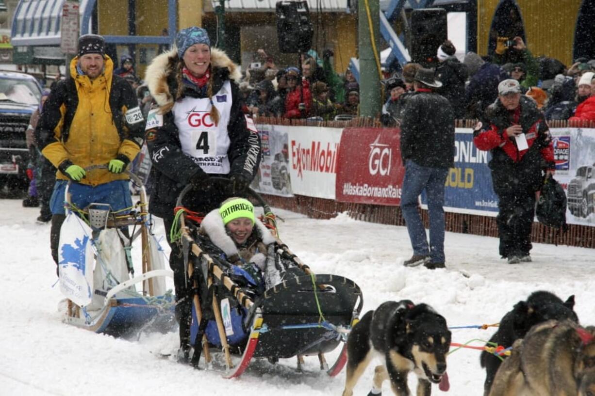 Musher Kristy Berington (bib No. 4) of Knik, Alaska, leaves the start line before the ceremonial start of the Iditarod Trail Sled Dog Race Saturday, March 7, 2020, in Anchorage, Alaska. The real race starts March 8 about 50 miles north of Anchorage, with the winner expected in the Bering Sea coastal town of Nome about 10 or 11 days later.