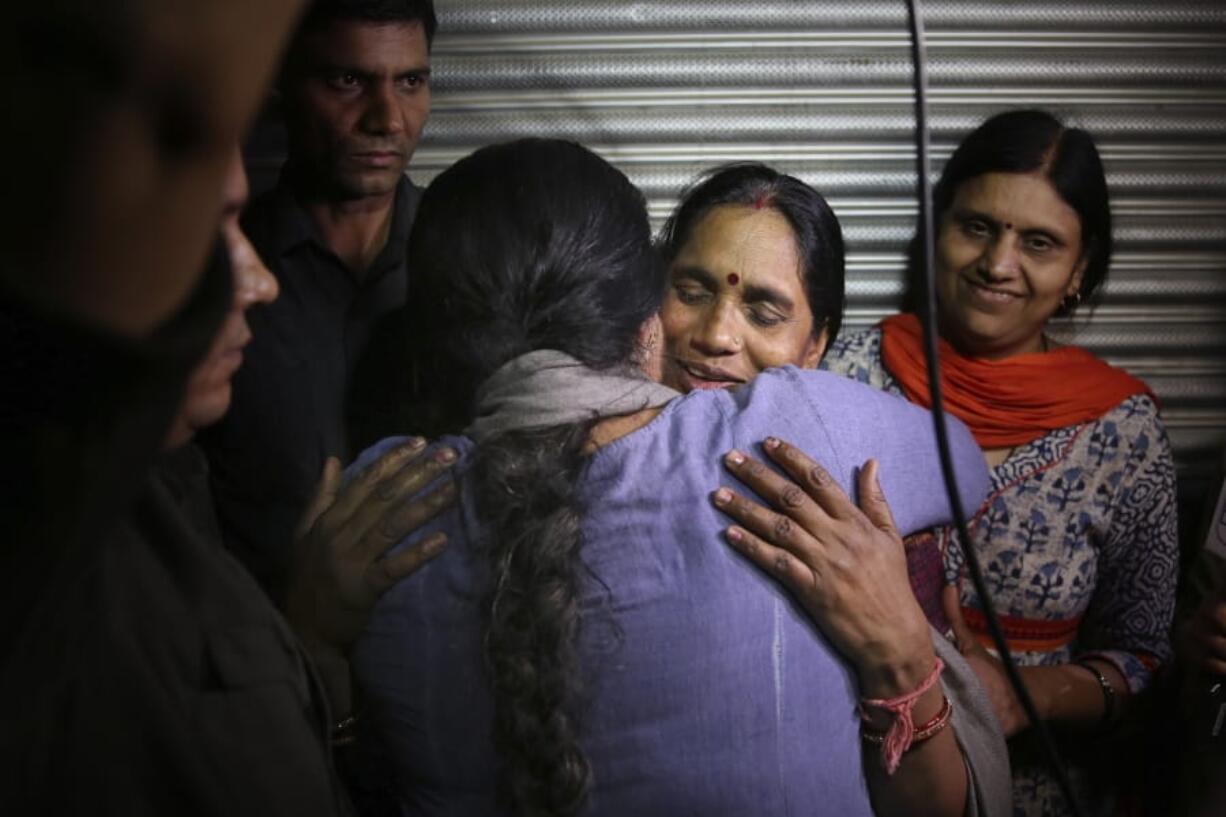 Asha Devi, mother of the victim of the fatal 2012 gang rape on a moving bus, facing camera, is embraced by an unidentified woman after the rapists of her daughter were hanged in New Delhi, India, Friday, March 20, 2020. Four men were sentenced to capital punishment for the 2012 gang-rape of a 23-year-old physiotherapy student on a moving bus in New Delhi have been executed.