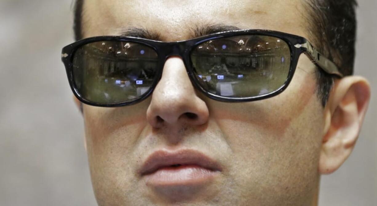 FILE - In this Jan. 5, 2017 file photo, rows of desks in the Washington Senate chamber are reflected in the glasses of Lt. Gov. Cyrus Habib, who is blind, as he stands at the Senate chamber dais at the Capitol in Olympia, Wash. Habib announced on Thursday, March 19, 2020, that he is not running for re-election and will join the Jesuit order of the Catholic Church as he starts the process of becoming a priest. (AP Photo/Ted S.