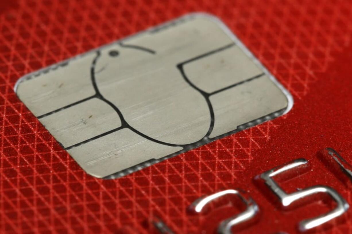 FILE- This June 10, 2015, file photo shows a chip credit card in Philadelphia. Brushing up on the basics of your credit score can give you a fresh start this year and help you know how best to build and defend it.