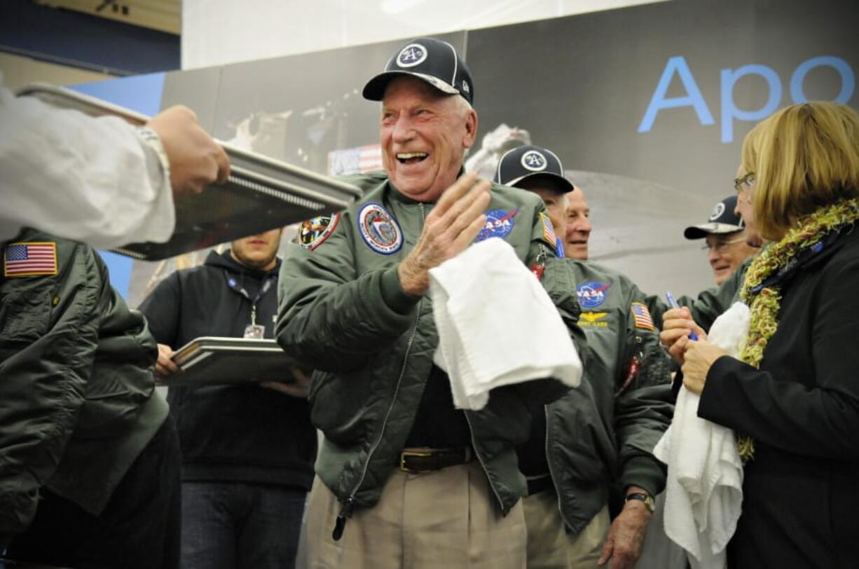 FILE - In this Wednesday, Nov. 12, 2014 file photo, Apollo 15 astronaut Al Worden wipes his hands after creating a cast of his hand prints that will be part of a permanent display at Apollo High School in St. Cloud, Minn. Worden, who circled the moon alone in 1971 while his two crewmates tried out the first lunar rover, has died at age 88, his family said Wednesday, March 18, 2020. (Jason Wachter/St.