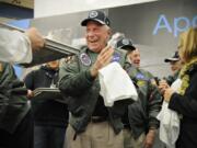 FILE - In this Wednesday, Nov. 12, 2014 file photo, Apollo 15 astronaut Al Worden wipes his hands after creating a cast of his hand prints that will be part of a permanent display at Apollo High School in St. Cloud, Minn. Worden, who circled the moon alone in 1971 while his two crewmates tried out the first lunar rover, has died at age 88, his family said Wednesday, March 18, 2020. (Jason Wachter/St.