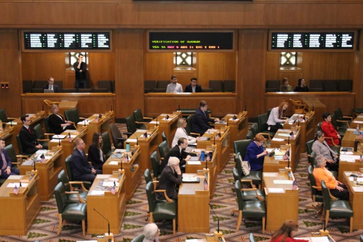 Members of the Oregon House of Representatives sit at their desks in Salem, Ore., during a roll call, Monday, March 2, 2020, for a roll call. A walkout by most Republican members entered its second week, and again prevented the House from convening.