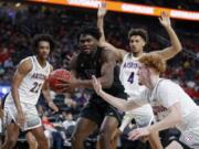 Washington&#039;s Isaiah Stewart (33) grabs a rebound over Arizona&#039;s Nico Mannion, right, during the first half of an NCAA college basketball game in the first round of the Pac-12 men&#039;s tournament Wednesday, March 11, 2020, in Las Vegas.