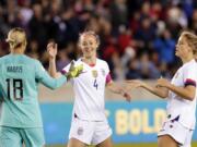 U.S. goalkeeper Ashlyn Harris (18), defender Becky Sauerbrunn (4) and defender Abby Dahlkemper, right, celebrate the team&#039;s 8-0 win over Panama in a CONCACAF women&#039;s Olympic qualifying soccer match Friday, Jan. 31, 2020, in Houston.