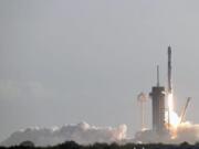 A Falcon 9 SpaceX rocket with a payload of approximately 60 satellites for SpaceX&#039;s Starlink broadband network lifts off from pad 39A at the Kennedy Space Center in Cape Canaveral, Fla., Wednesday, March 18, 2020.