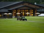 Members of the grounds crew work in 2008 in preparation for the second round of the Royal Oaks Invitational.