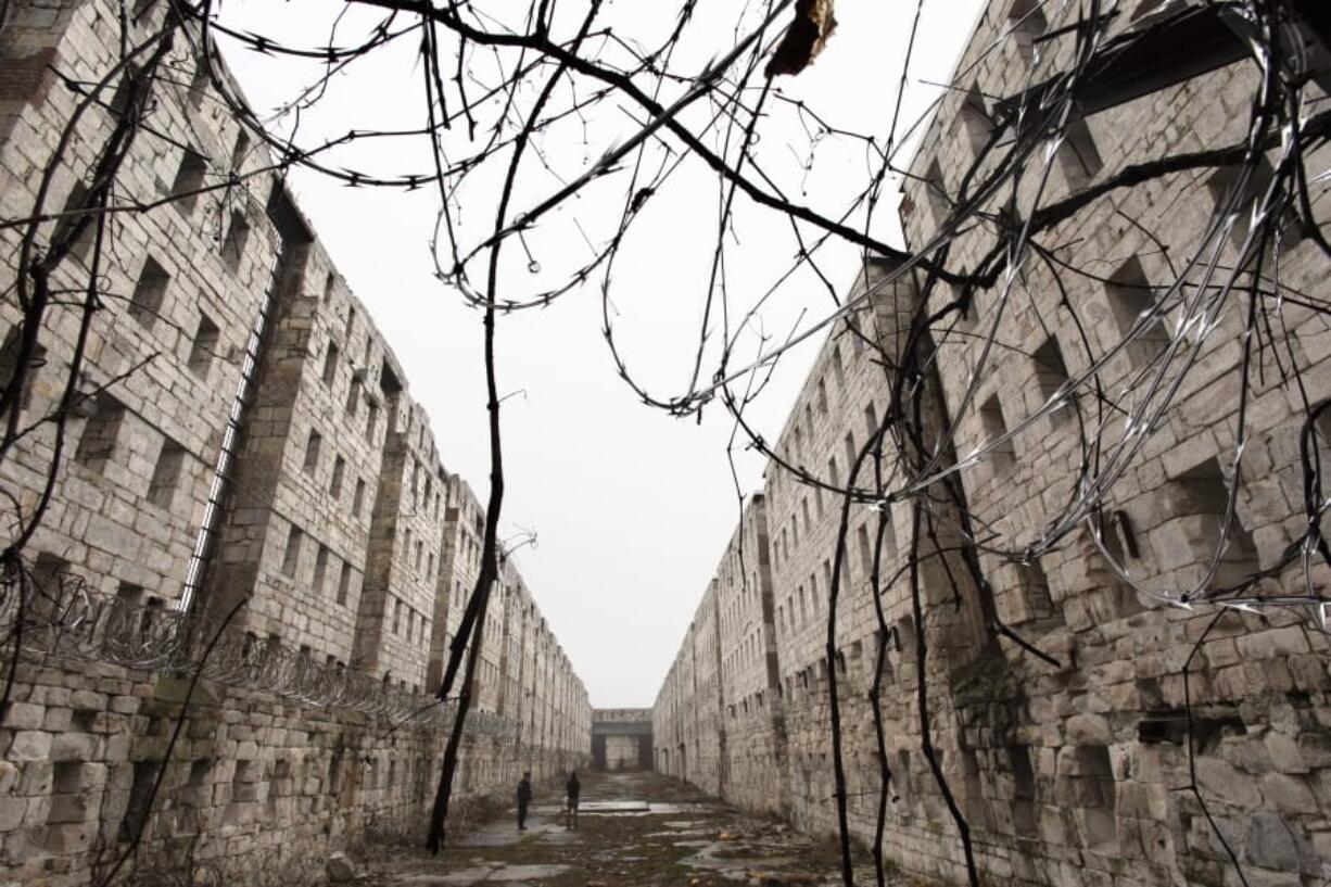 Concertina wire and vines line the stone walls of a former cell block Feb. 13 at Sing Sing Correctional Facility in Ossining, N.Y. A not-for-profit group is planning to open the Sing Sing Prison Museum in 2025.