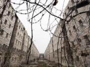 Concertina wire and vines line the stone walls of a former cell block Feb. 13 at Sing Sing Correctional Facility in Ossining, N.Y. A not-for-profit group is planning to open the Sing Sing Prison Museum in 2025.