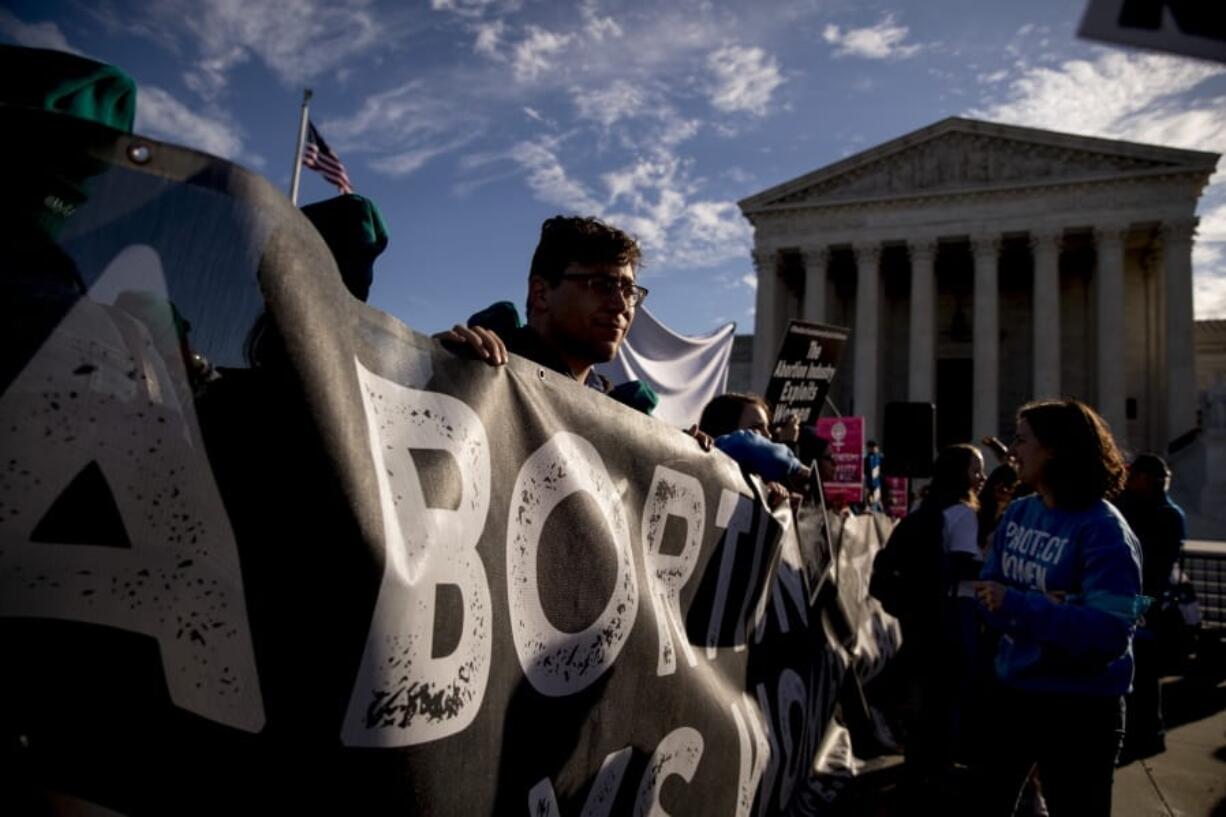 Anti-abortion rights demonstrators rally outside the Supreme Court, in Washington, Wednesday, March 4, 2020, as the court takes up the first major abortion case of the Trump era Wednesday, an election-year look at a Louisiana dispute that could reveal how willing the more conservative court is to roll back abortion rights.